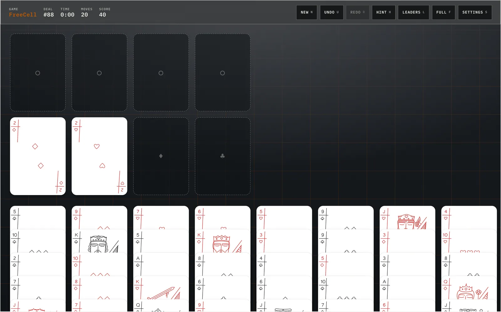 The same FreeCell game rendered on a near-black table with classic red and black suits