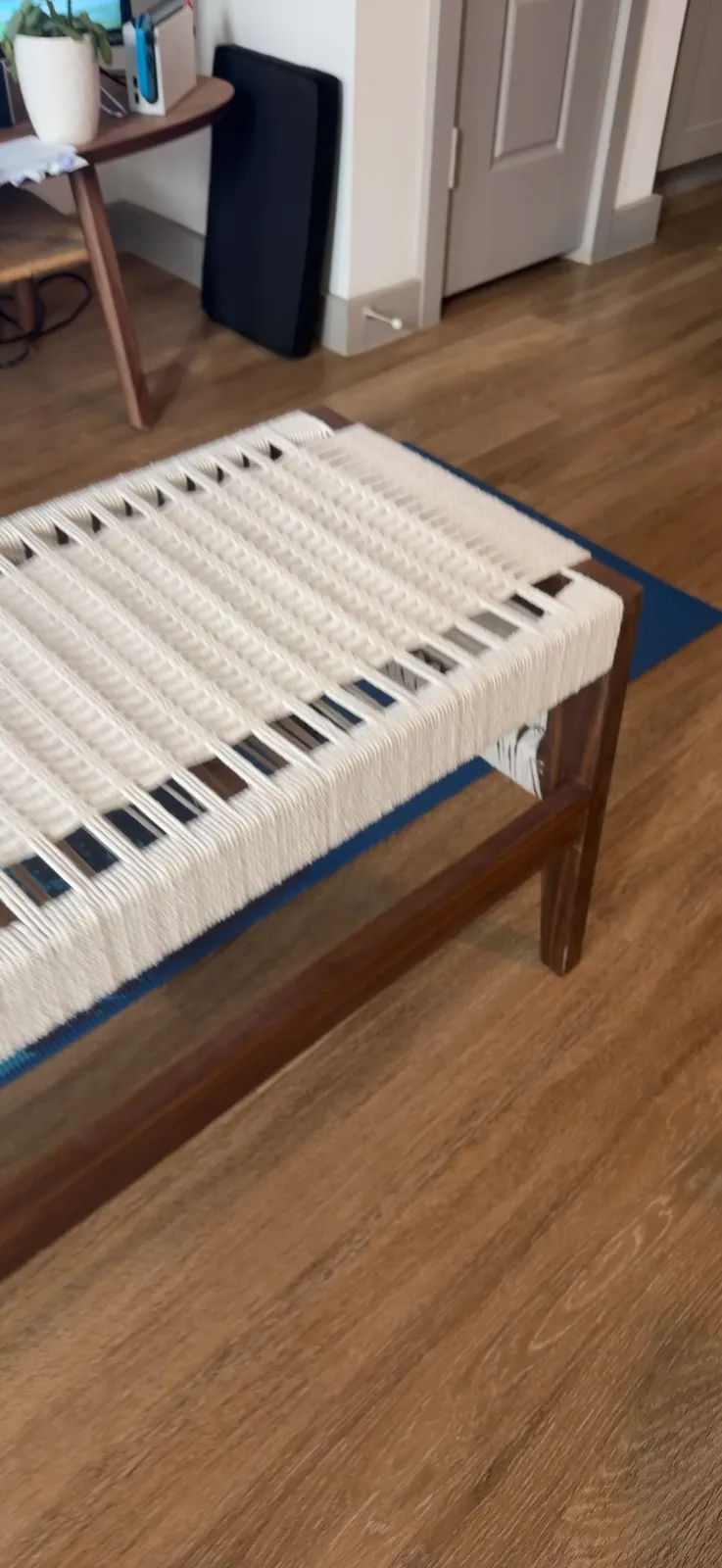 A short handheld video panning across the woven rope seat of the bench