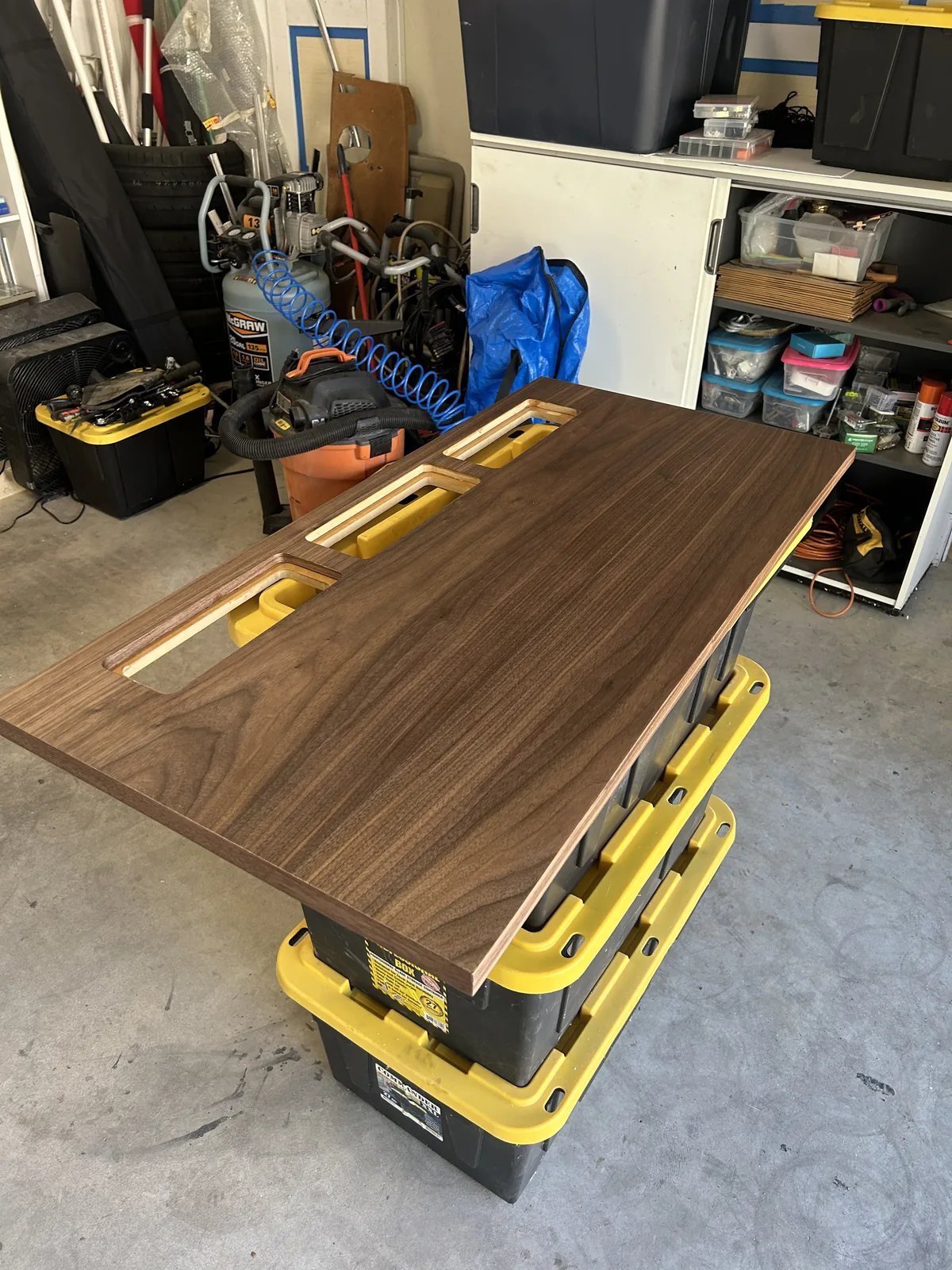 The walnut top seen end on at a low angle, the three ports lining up down the far edge