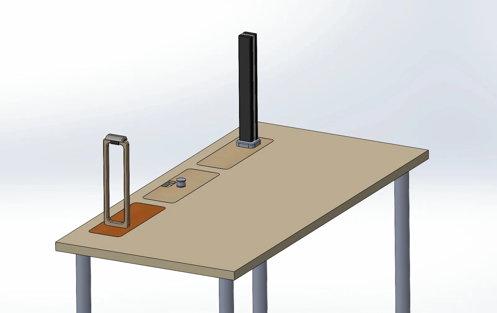 CAD view of the desk with an insert in each port, holding a tall open frame on the left, a small round part in the middle and a tall black lamp on the right